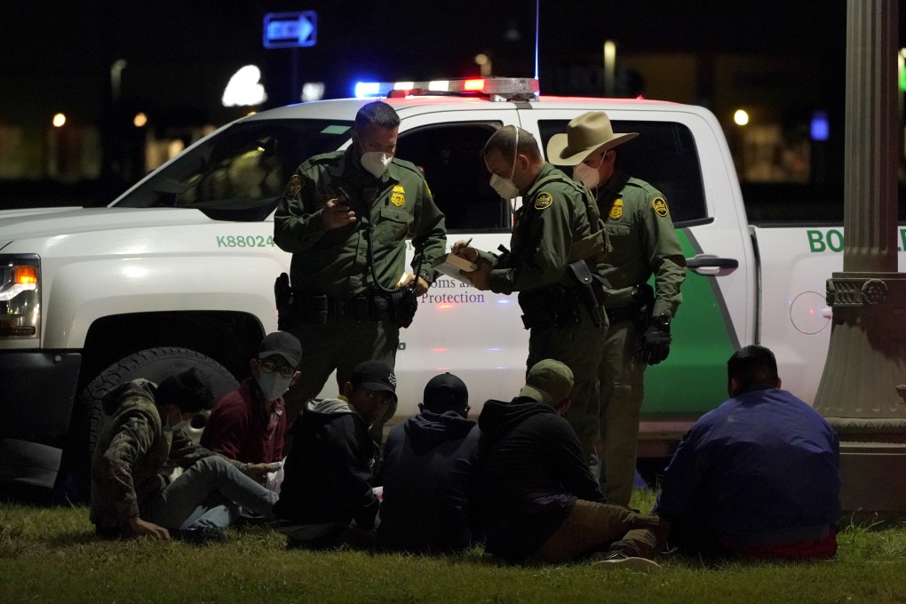 US Customs and Border Protection agents take people into custody near the US-Mexico border on Saturday. Photo: AP