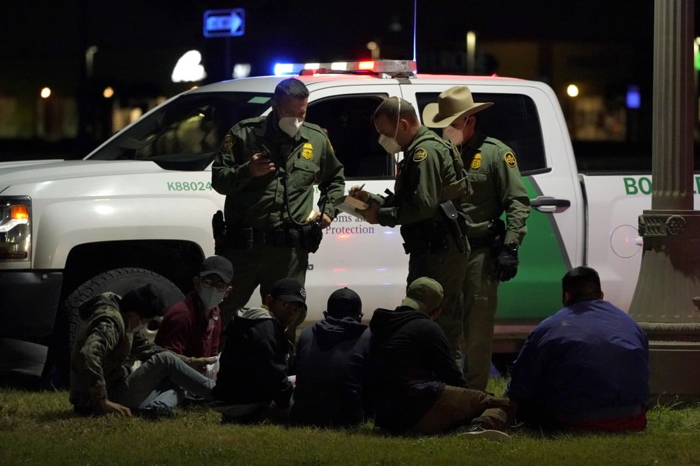US Customs and Border Protection agents take people into custody near the US-Mexico border on Saturday. Photo: AP