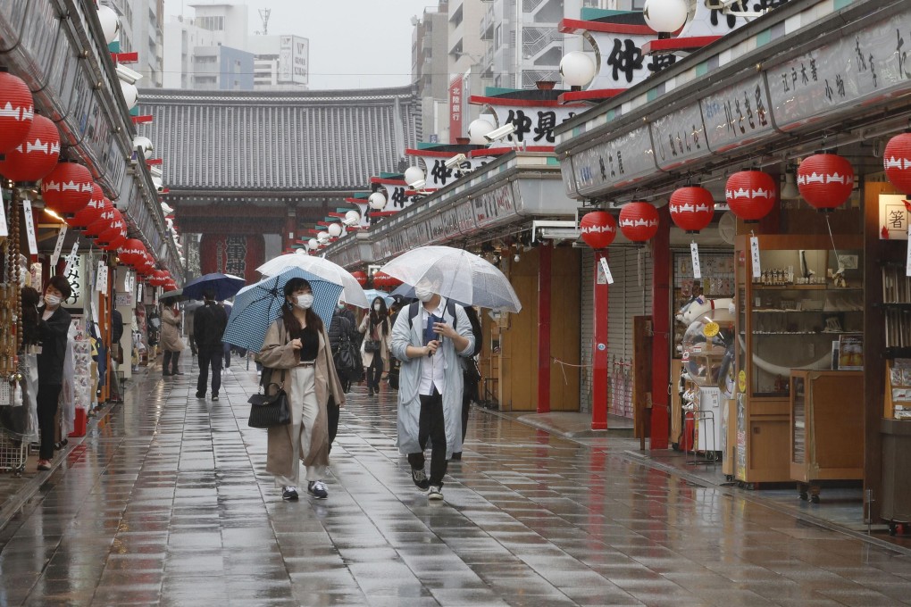 People walk in the rain in Tokyo’s Asakusa area on Sunday ahead of the scheduled lifting of the coronavirus state of emergency. Photo: Kyodo