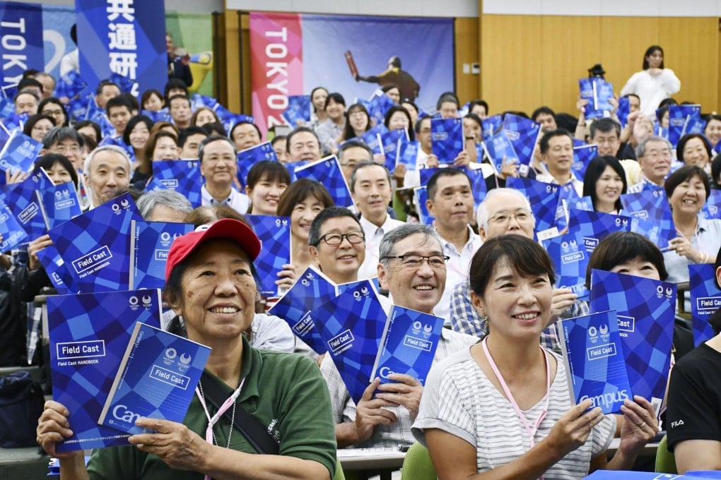 Volunteers for the 2020 Tokyo Olympics and Paralympics pose for a photo during a training session. Photo: Kyodo