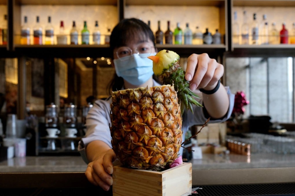 An employee prepares pineapple juice at the Courtyard restaurant at the Marriott hotel in Taipei. Photo: AFP