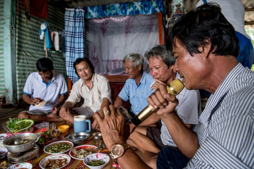 Shrimp farmers in the Mekong Delta enjoy a karaoke session during their group dinner. Photo: AFP