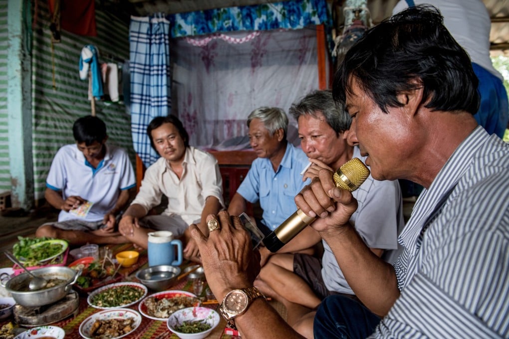 Shrimp farmers in the Mekong Delta enjoy a karaoke session during their group dinner. Photo: AFP