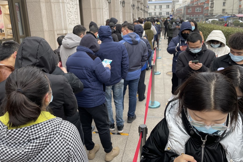 Hundreds of people line up outside a temporary vaccine centre at a building in Beijing. Photo: Simon Song
