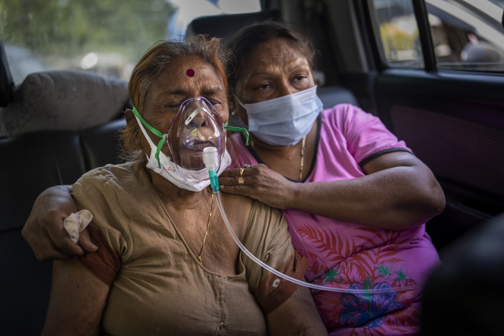 A Covid-19 patient receives oxygen inside a car in New Delhi on Saturday as India’s caseload reached record levels. Photo: AP