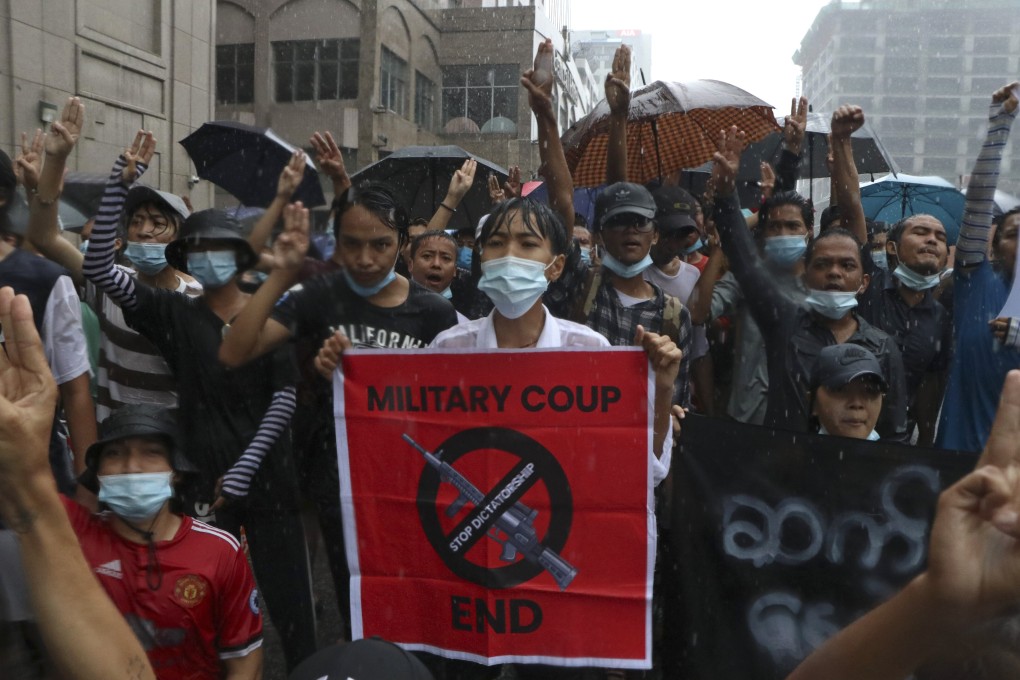 Anti-coup protesters flash the three-finger salute and chant slogans during a demonstration against the military coup in Yangon, Myanmar. Photo: AP