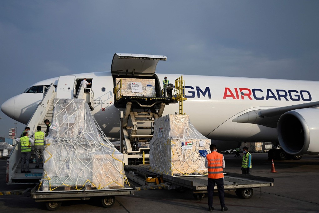 Ground staff unload the Covid-19 medical supplies from France at an airport in New Delhi. Photo: AFP