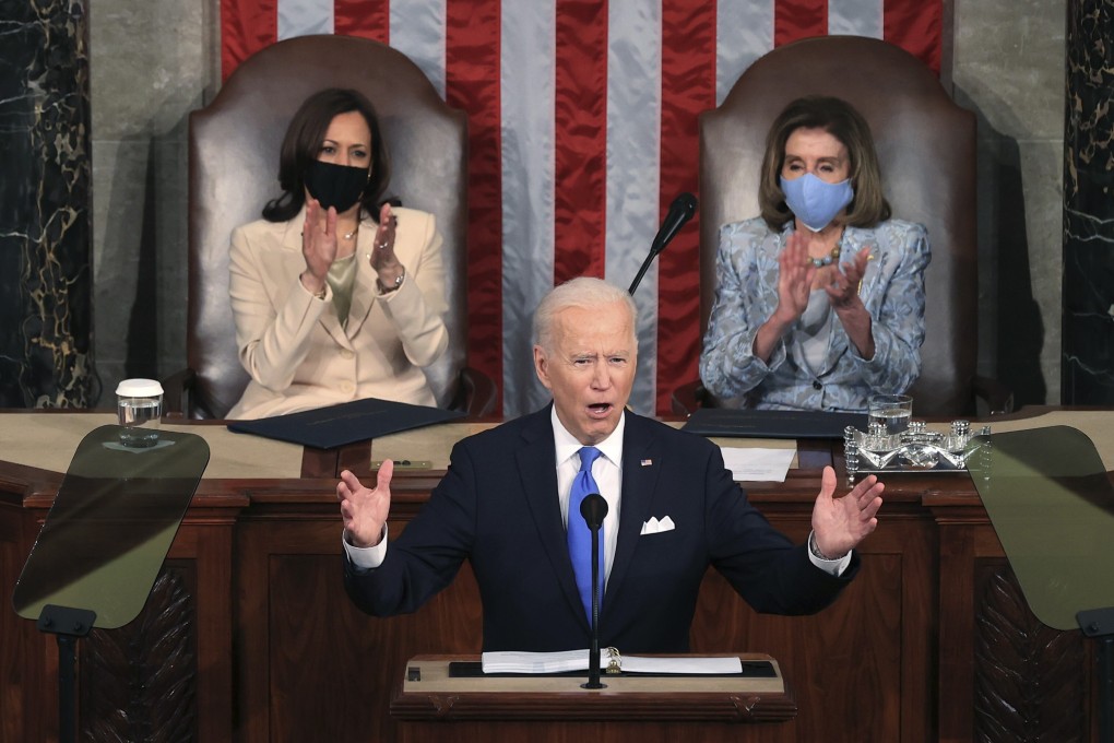 President Joe Biden addresses a joint session of the US Congress on April 28, one day shy of his 100th day in office, as Vice-President Kamala Harris (left) and House Speaker Nancy Pelosi look on. Photo: AP