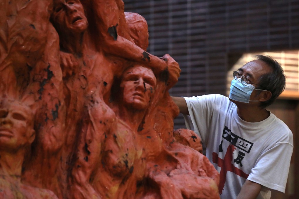 An alliance member cleans the Pillar of Shame on the HKU campus. Photo: Xiaomei Chen