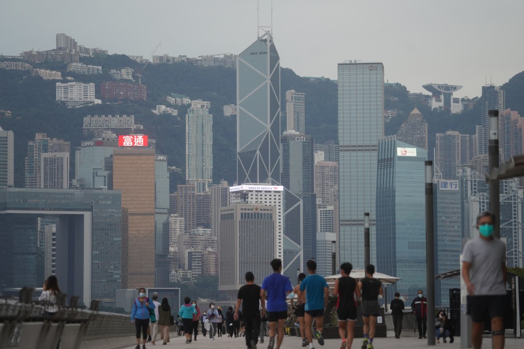 People stroll along the waterfront at Victoria Harbour, taking in Hong Kong’s iconic skyline. Photo: Winson Wong