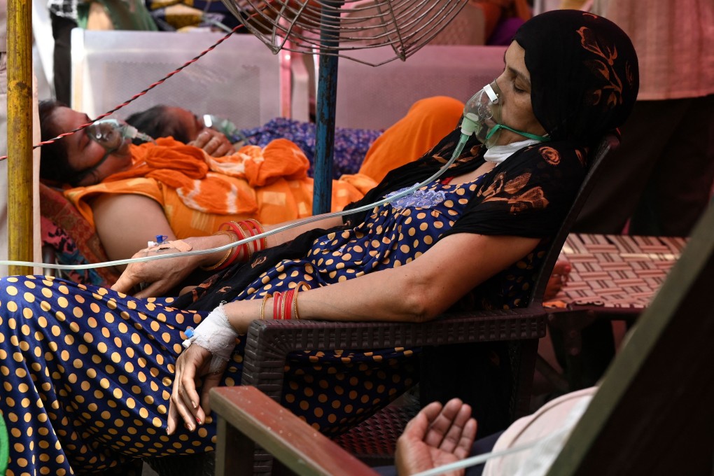 Patients breathe with the help of oxygen provided at a Sikh temple in Ghaziabad, India. Photo: AFP