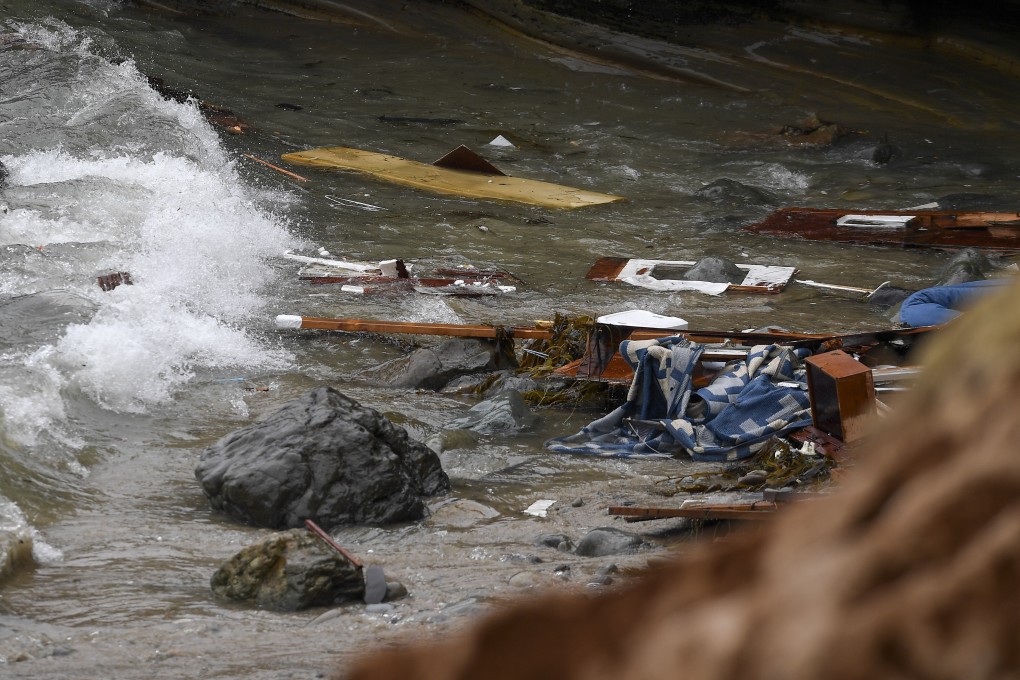Wreckage and debris from a capsized boat washes ashore at Cabrillo National Monument off the San Diego coast on Sunday. Photo: AP