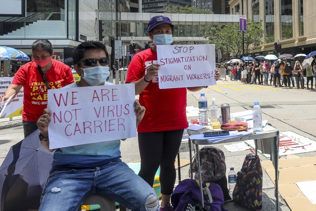 Foreign domestic helpers petition against the new rules mandating blanket Covid-19 testing and vaccinations on Chater Road in Central, Hong Kong, on May 1. Photo: Xiaomei Chen