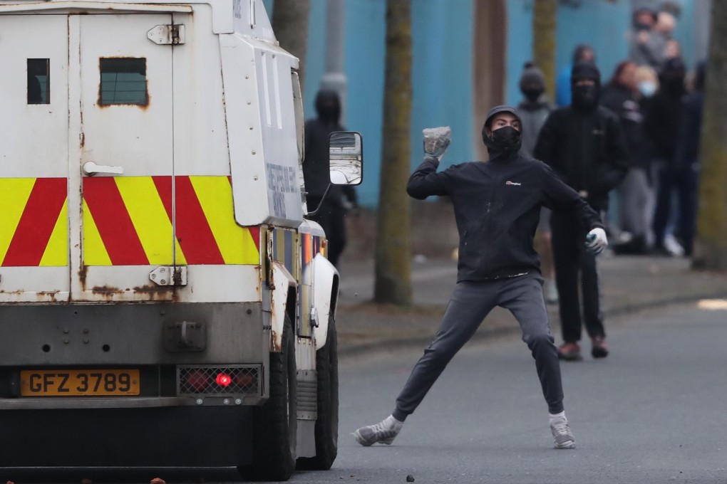 A protester throws a stone at police in Belfast on April 19. Post-Brexit trade barriers helped trigger some of the worst violence in the region in years. Photo: DPA