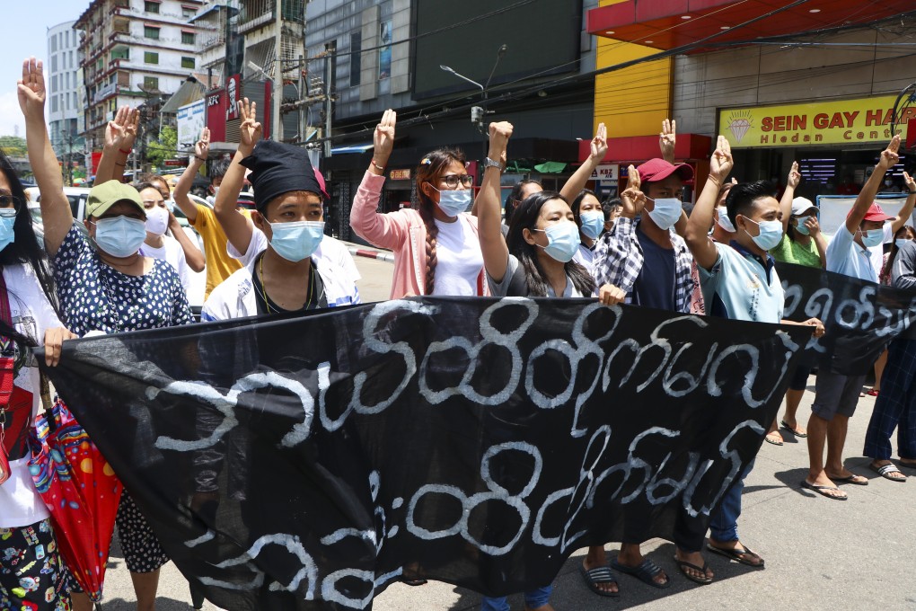 Anti-coup protesters display the three-fingered salute. Photo: AP