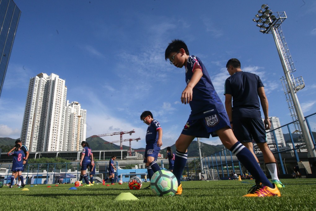 Children play football at Jockey Club Kitchee Centre in Shek Mun. Photo: David Wong