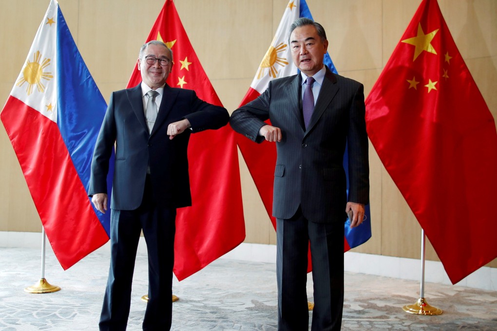 Philippine Secretary of Foreign Affairs Secretary Teodoro Locsin Jnr bumps elbows with China‘s Foreign Minister Wang Yi during a meeting in Manila in January. Photo: Reuters