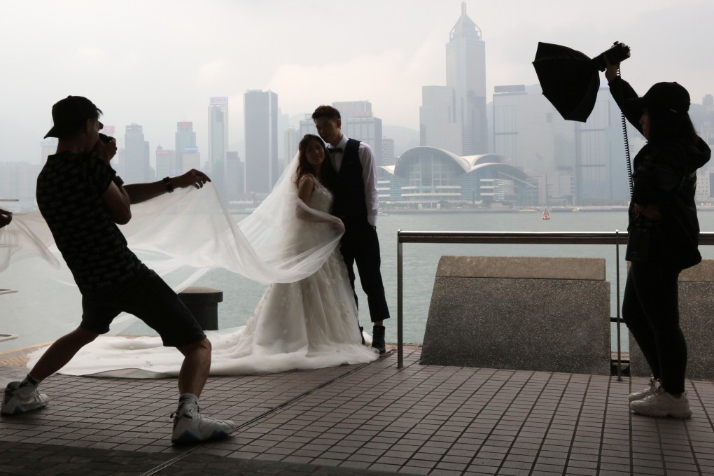A couple poses for wedding photos in Tsim Sha Tsui. Hong Kong’s Immigration Department has hit back in the wake of the Audit Commission’s latest report regarding enforcement in fake marriages. Photo: Felix Wong