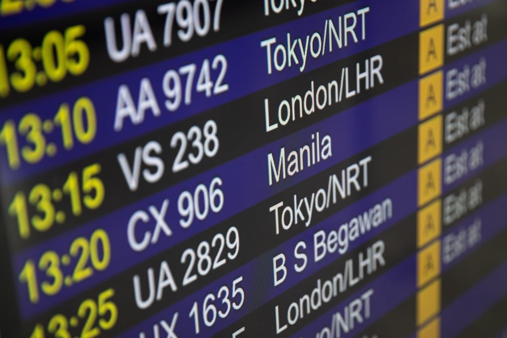 An electronic signboard displays flights information in the arrival hall at Hong Kong International Airport April 20. Hong Kong is set to lift the ban on passenger flights from the UK this week. Photo: EPA-EFE