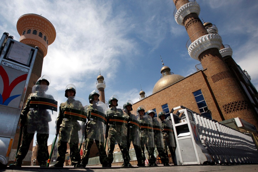 Chinese paramilitary police in riot gear outside a mosque in Urumqi, the capital of Xinjiang. Photo: Reuters