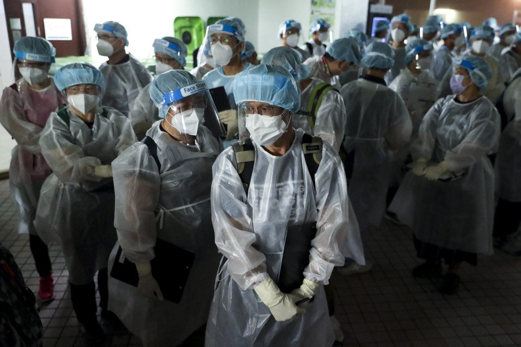 Medical workers in protective gear arrive at Block R of Allway Garden. Photo: Edmond So
