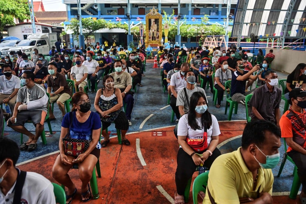 People wait to receive Covid-19 vaccinations at a school in Bangkok. Photo: AFP