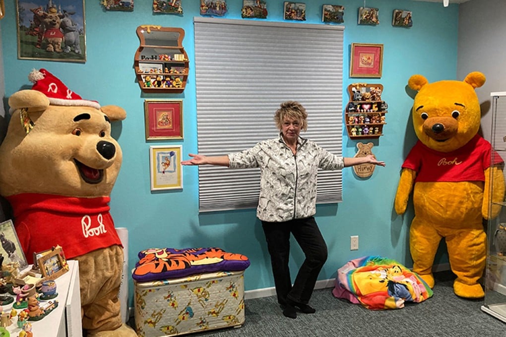 Collector Deb Hoffmann with a Winnie the Pooh costume used at Disney parks in the 1960s and 1970s (left), and one used in Sears stores during the 1970s and 1980s (right). Photo: TNS