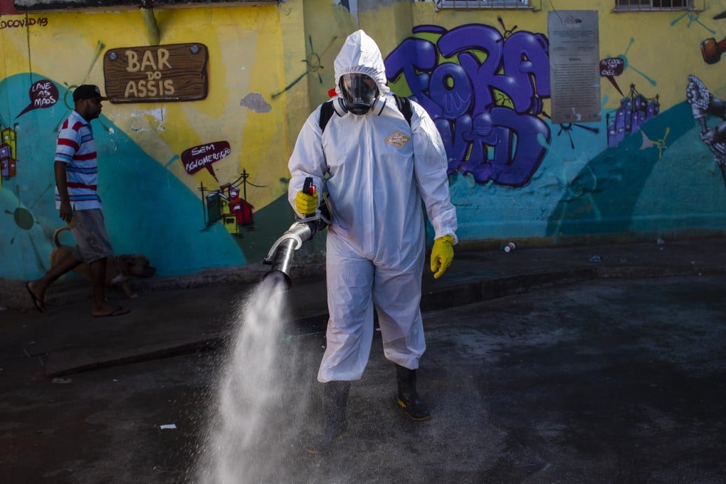 A health worker sprays disinfectant in a Rio de Janeiro slum. Photo: AP