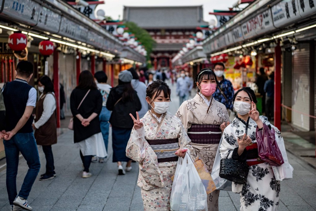 Women in traditional outfits and face masks visit Sensoji temple in Tokyo. Photo: AFP