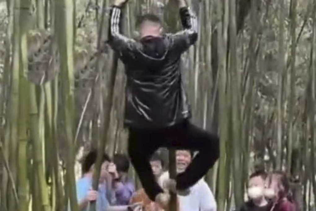 Tourists climbing on bamboo at the sacred Shaolin Temple site in Henan, central China. Photo: Handout