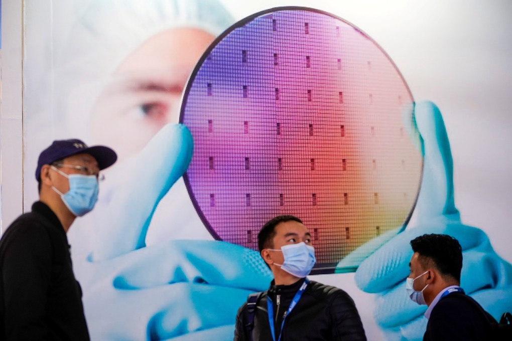 People in front of a display of a semiconductor device at Semicon China, a trade fair for semiconductor technology in Shanghai, on March 17. Photo: Reuters