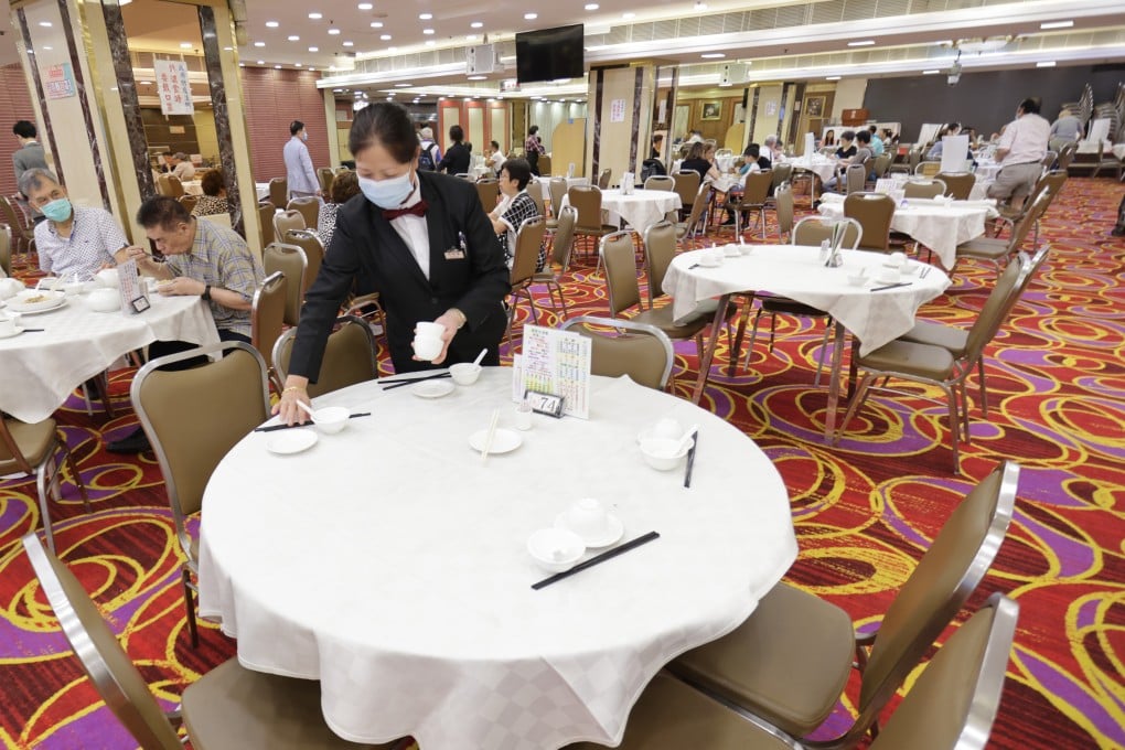 A staff member sets a table at the London Chinese Restaurant in Mong Kok, one of many unable to take advantage of newly relaxed rules. Photo: May Tse
