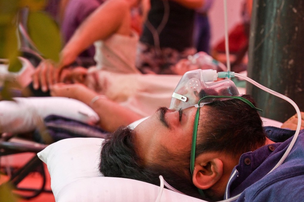 A Covid-19 coronavirus patient breathes with the help of oxygen in a tent in Ghaziabad, India. Photo: AFP
