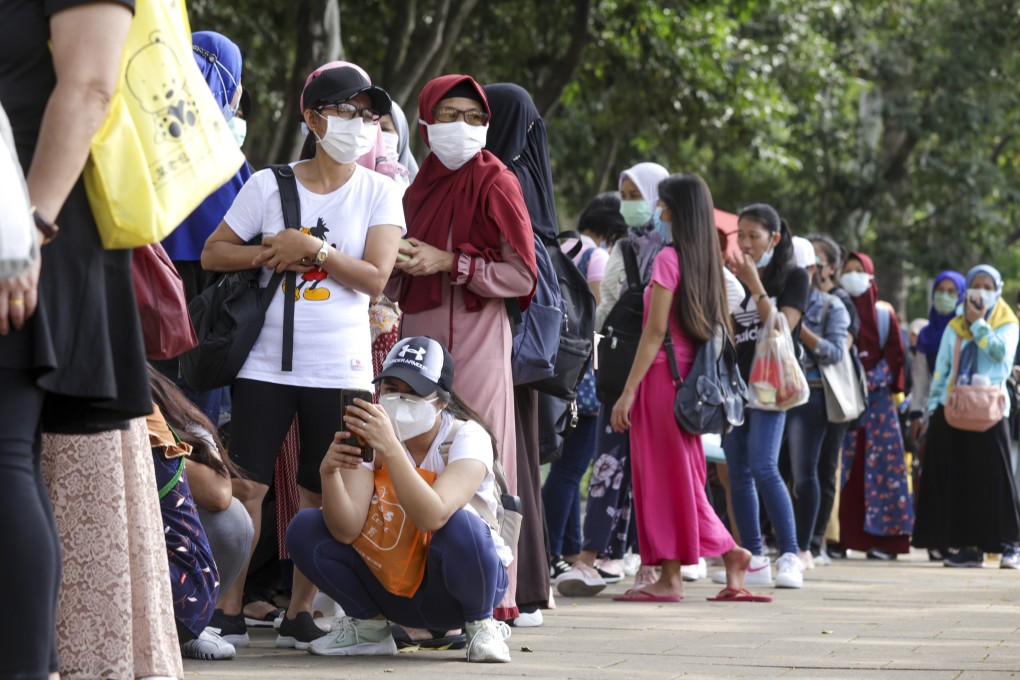 Domestic helpers queue up for Covid-19 tests in Causeway Bay. Photo: May Tse