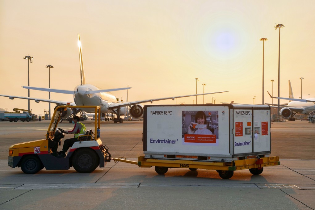 Containers carrying Sinovac Covid-19 vaccines are unloaded from a Cathay Pacific plane at Hong Kong International Airport on February 19. To qualify for travel bubble flights between Hong Kong and Singapore, travellers from Hong Kong must be vaccinated – but not travellers from Singapore. Photo: SCMP Pictures