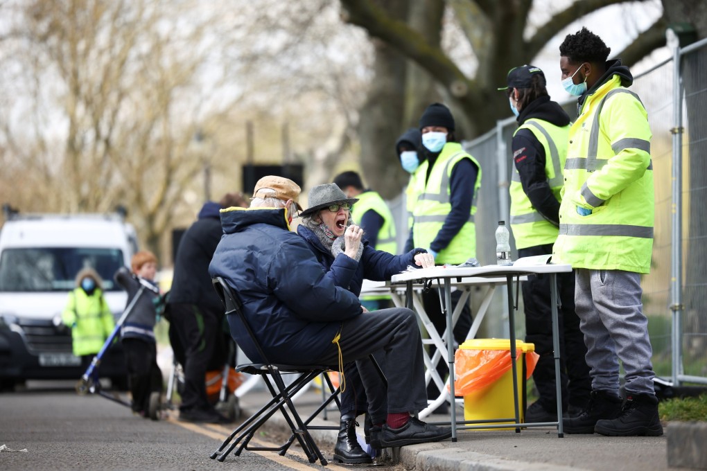 People swab themselves for Covid-19 at a testing site in London. File photo: Reuters