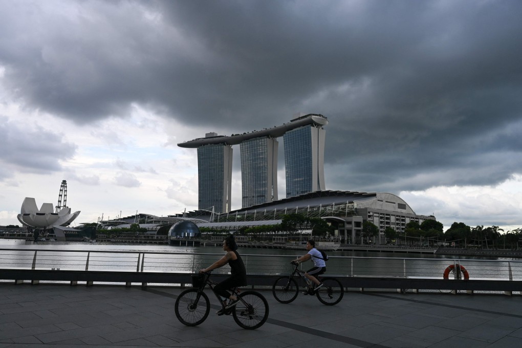 People cycle along the Marina Bay promenade in Singapore. Photo: AFP