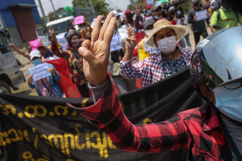 A demonstrator flashes the three-finger salute during an antimilitary coup protest in Mandalay, Myanmar, on Saturday. Photo: EPA