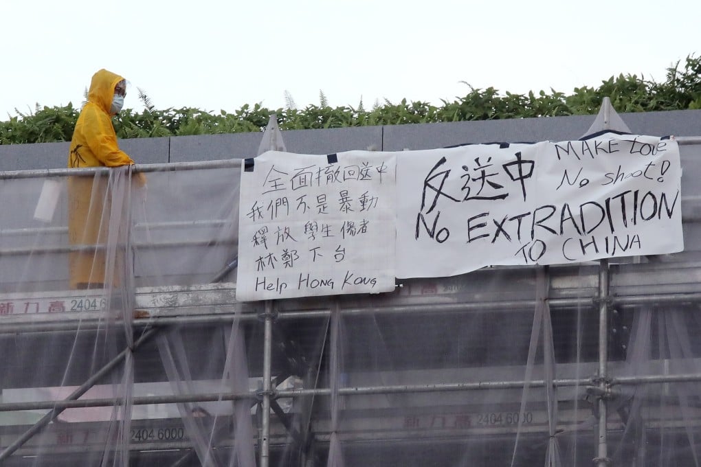 Marco Leung is seen standing on scaffolding outside Pacific Place on the day he fell to his death in 2019. Photo: K. Y. Cheng