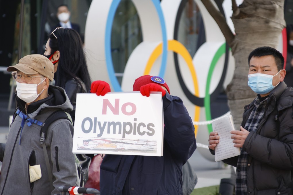 A protester holds a placard during an anti-Olympics rally outside the Japan Olympic Museum in February. Photo: DPA