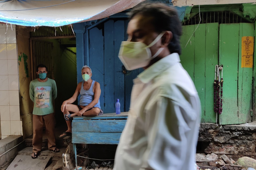 A shopkeeper wearing mask as a precaution against the coronavirus rests outside his closed shop in Prayagraj, India, on Sunday, May 9, 2021. Photo: AP Photo