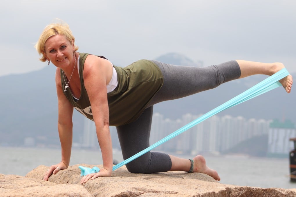 Corinne Clifford does a Pilates workout on a beach in Lamma, Hong Kong. A former Macau showgirl, who spent seven enjoyable years on stage, Clifford turned to Pilates to keep herself in shape. Photo: Annemarie Evans