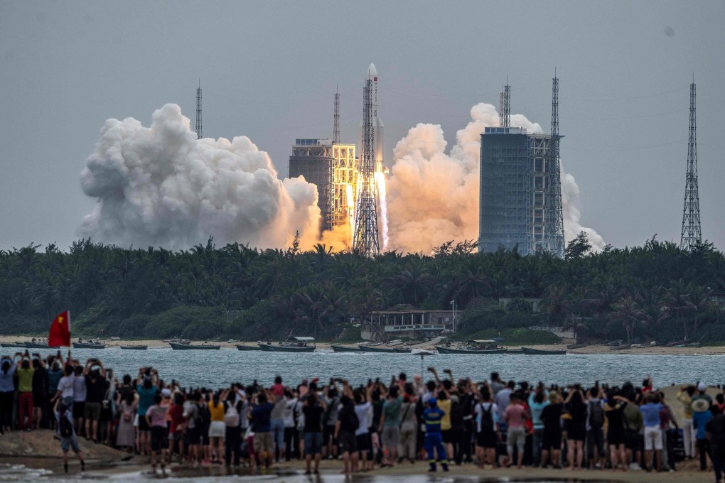 People watch a Long March 5B rocket, carrying China’s Tianhe space station core module, as it lifts off from the Wenchang Space Launch Centre in southern China’s Hainan province on April 29. Photo: AFP