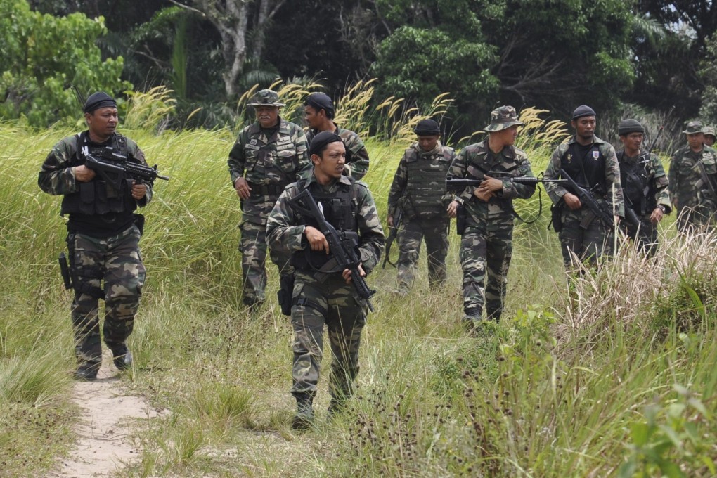 Malaysian soldiers seen on patrol during an operation in Sabah state. Photo: Handout via EPA