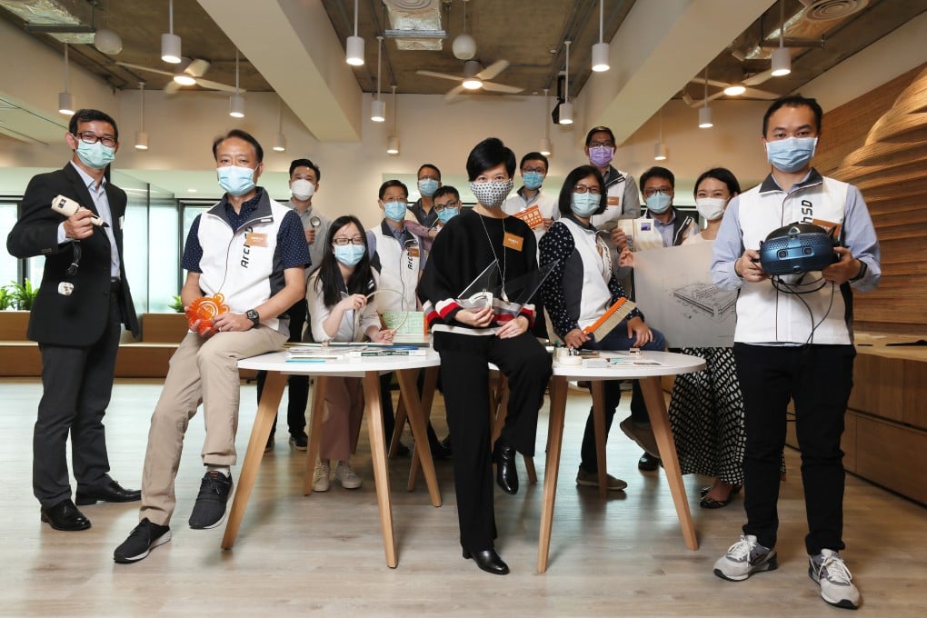Winnie Ho (centre) with staff from the Architectural Services Department that she leads. Photo: Xiaomei Chen