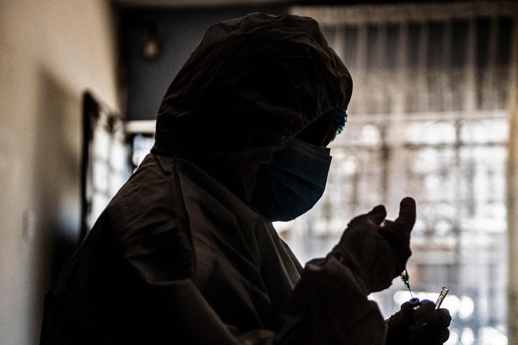 A health worker prepares a dose of the Pfizer-BioNTech vaccine at a house in Lima, Peru. Photo: AFP
