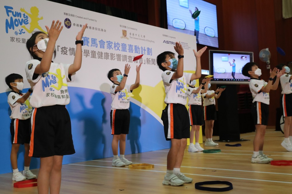 Pupils exercise with the help of online instruction at a promotional event for the release of the survey at Yaumati Catholic Primary School (Hoi Wang Road) on Tuesday. Photo: Edmond So