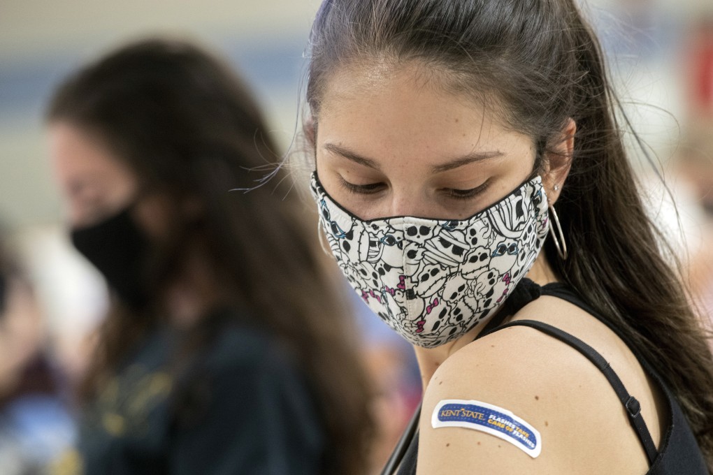 A US university student looks at her vaccination bandage after getting her Covid-19 shot in Kent, Ohio, in April. Photo: AP
