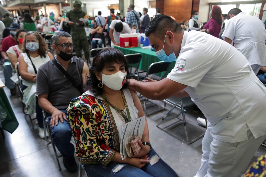 A woman receives a dose of the Pfizer/BioNTech Covid-19 vaccine in Mexico City. Photo: Reuters