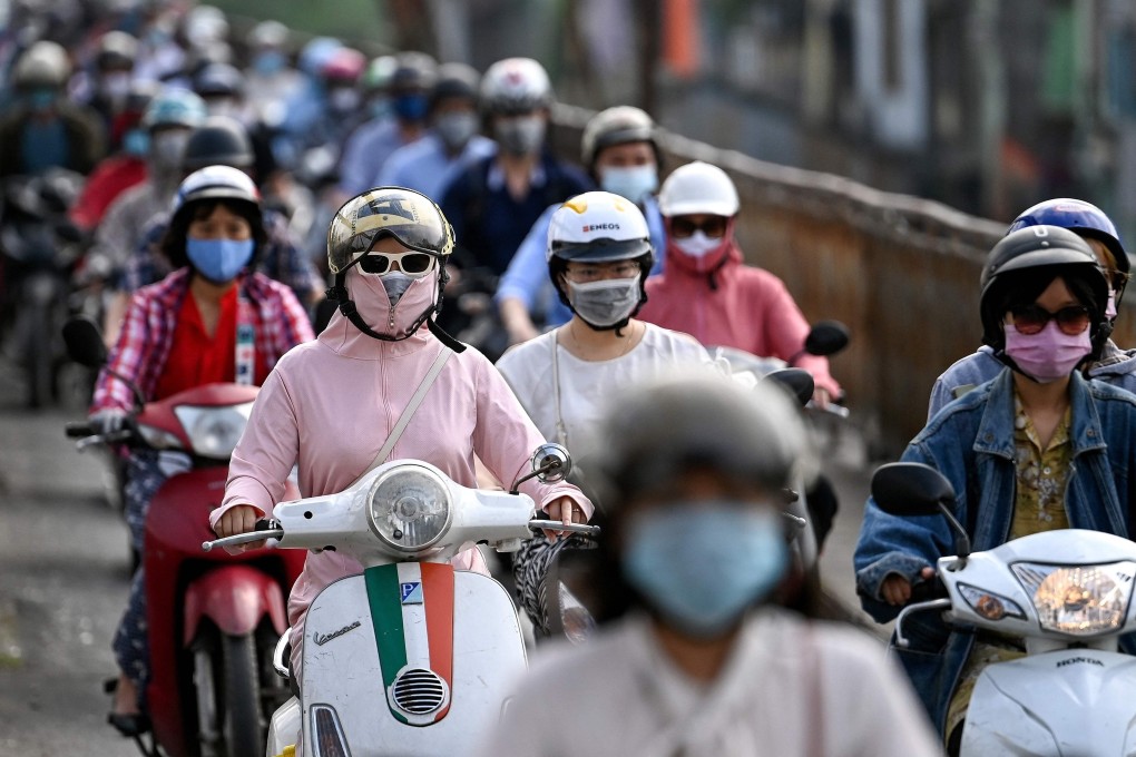 Morning commuters wearing face masks, amid concerns over Covid-19, in Hanoi. Photo: AFP
